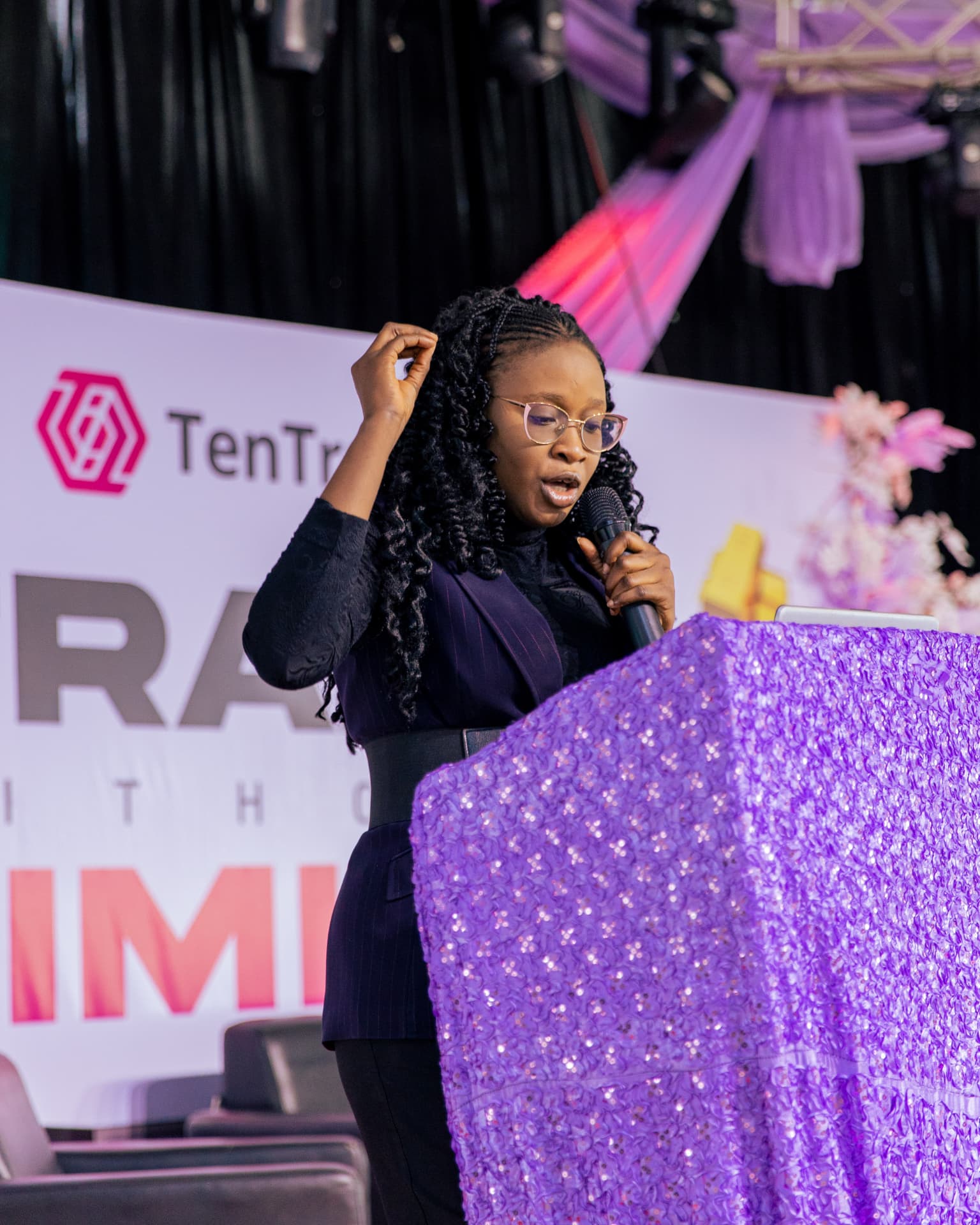 Speaking from a podium at the TenTrade Trade Without Limits event